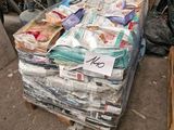 a pile of newspapers sitting on top of a pallet