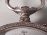 a close up view of a pocket watch with a key