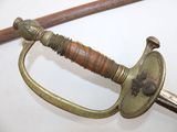 a sword with a wooden handle on a white surface