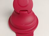 a red lid on a red cup on a white table