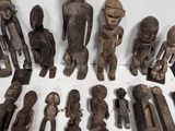 a lot of old wooden figurines on a table