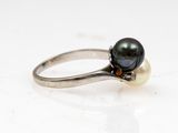 an image of a ring with a black pearl and a diamond