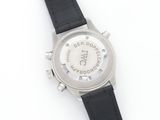 a close up of a watch on a white surface with a black strap