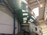 a reflection of a plane in a mirror in a hangar