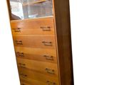 an image of a tall wooden cabinet with glass doors