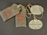 three tags with numbers on them hang on a string