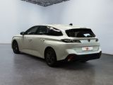 the rear end of a white toyota mira parked in a room