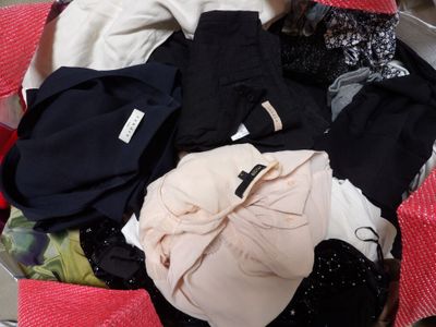 a suitcase full of clothes sitting on the floor