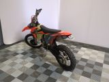 an image of a dirt bike parked on a checkered floor