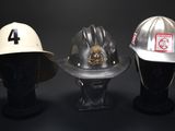 three different types of fire hats on a mannequin head