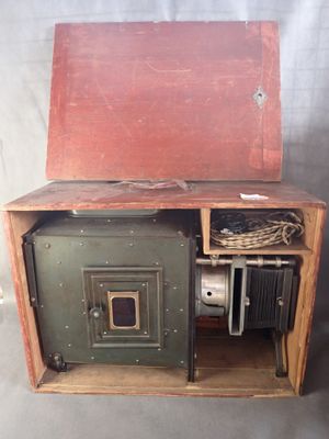 an old wooden box with a metal door on it