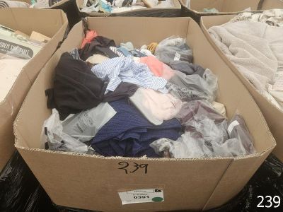 a cardboard box filled with clothes and other items