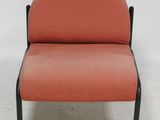 an orange chair with black legs and a black frame