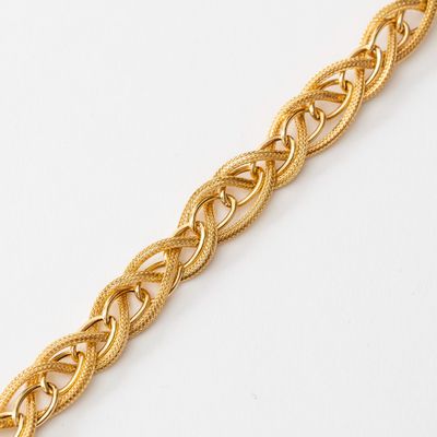 a close up of a gold bracelet on a white surface