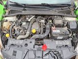 a green car with its hood open and the engine in the back
