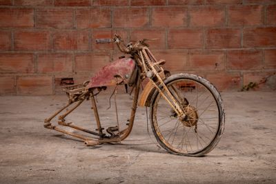an old motorcycle that is sitting in the dirt