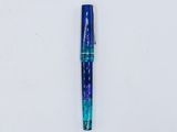 a close up of a pen laying on top of a white surface