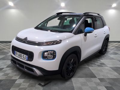 the white citrole is parked on a checkered tile floor