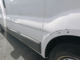 a white van that is parked on the side of the road