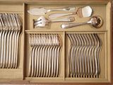 a wooden box with silverware in it on a table