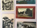 several old photographs of people and a dog are on a table