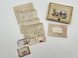 several pieces of old paper and other items on a white surface