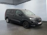 the black van is parked in a large room with a white wall