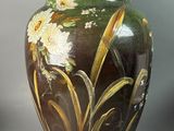 two vases with flowers painted on them on a table