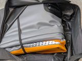 a black bag filled with clothes on the floor