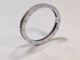 a close up of a ring on a table with a white background