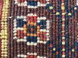 a close up of a colorful rug with a pattern on it