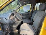 the interior of a small yellow van with a steering wheel