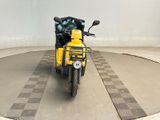 a yellow scooter that is parked in a parking lot