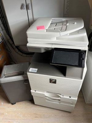 a printer sitting on top of a stack of boxes