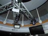 an image of a large telescope in a building