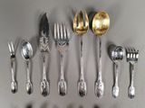 a lot of silver spoons and forks on the table