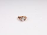 a close up of a diamond ring on a white surface