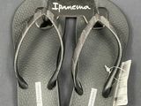 a pair of flip flops that have a tag on them
