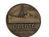 a coin with a ship on it that says libertte