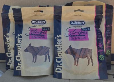 two bags of dog food sitting on a counter