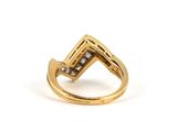 a close up of a gold ring with diamonds on it