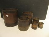 a group of old pots and cups sitting on a table