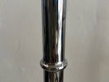 a close up of a silver metal vase on a table