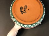 a bowl of soup on a table with a spoon in it