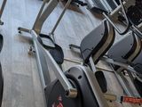 a row of stationary exercise bikes in a gym