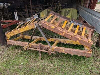 a picture of a tractor with a wooden pallet attached to it ' s back