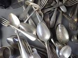 many silver spoons and spoon spoons on the table