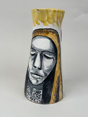 a vase with a painting of a woman on it