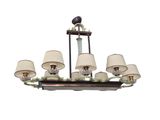 a chandelier with six lamps and a bird on it