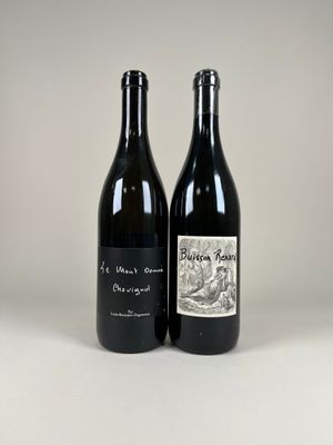 two bottles of wine sitting next to each other on a table
